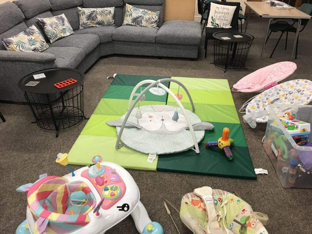 Hall with comfy sofa and baby cradles and crawling mat