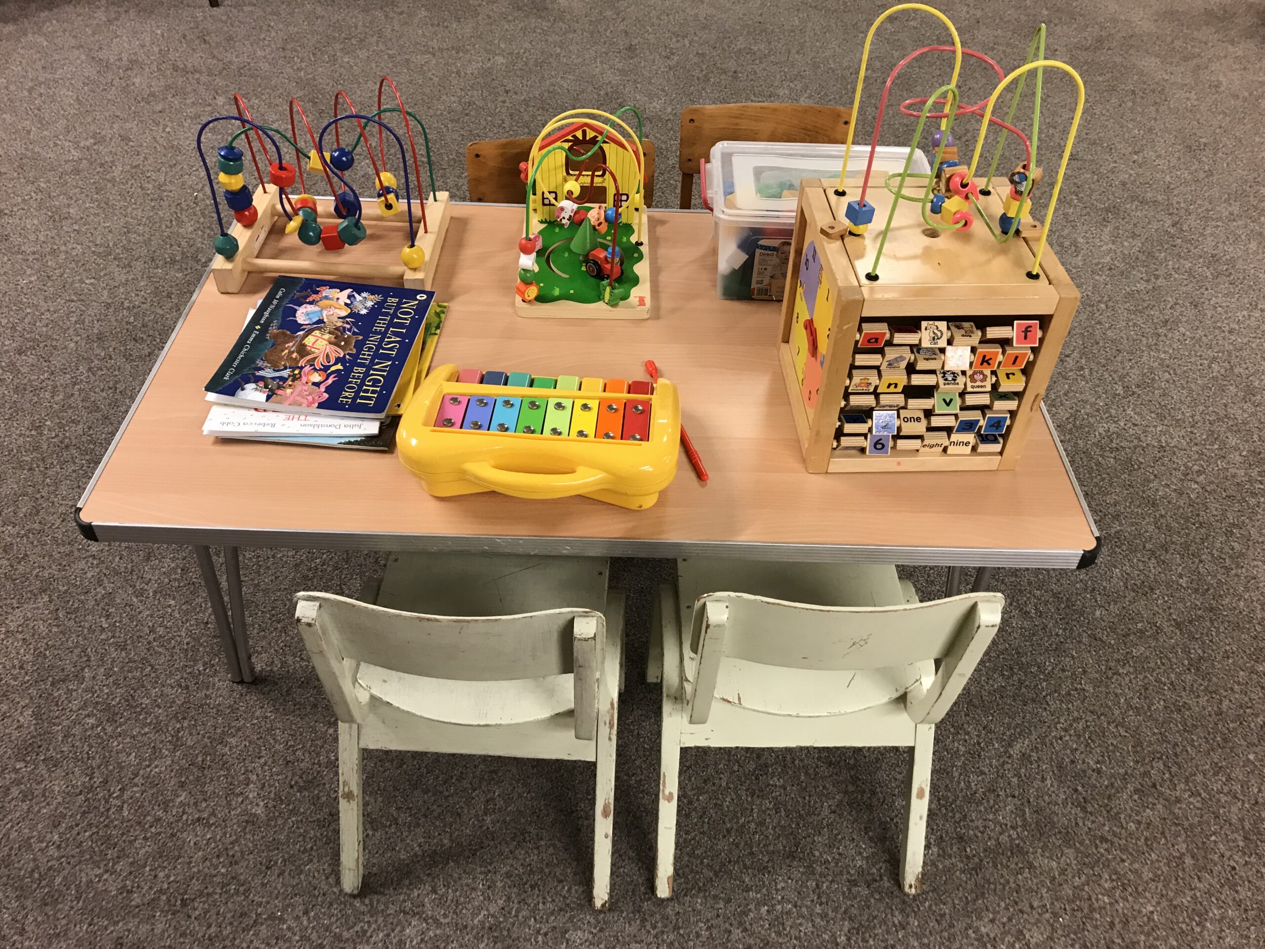 Children's table with toys and seats around