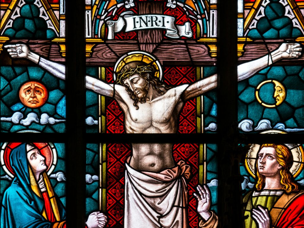stained glass window showing Jesus on cross